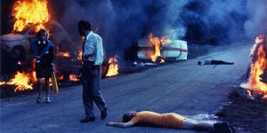 An image from Jean-Luc Godard's "Weekend". Frustrated drivers, stuck in an endless traffic jam,  start attacking each other.