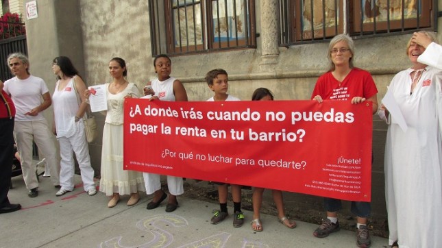 Protesters holding a banner to protest evictions.