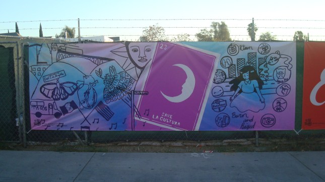 Banner on fence at a construction site on First Street.  Art by Gabriella Claro, Salma Sosa, and Tatei Torres Thomas.