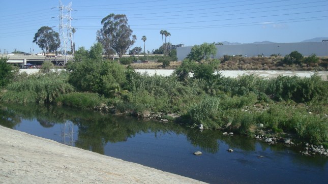A shot of the river with the freeway in the background.
