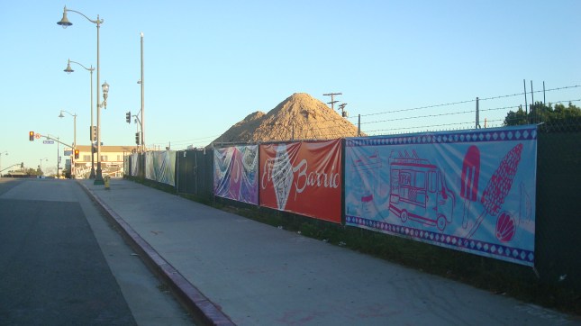 A row of banners at a construction site, First and Boyle