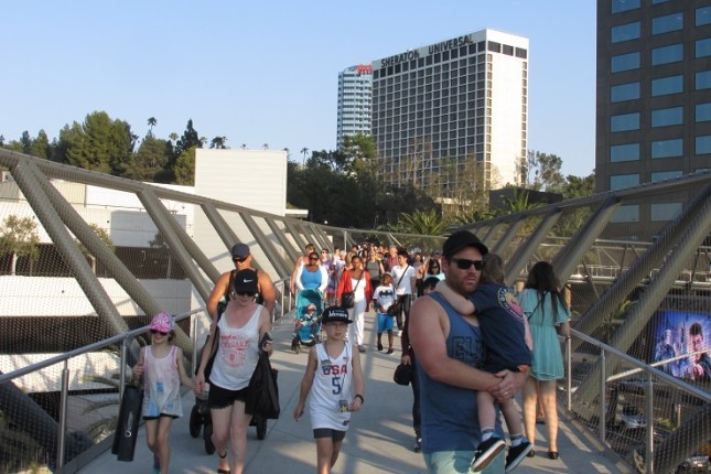 A crowd of people leaving the theme park.