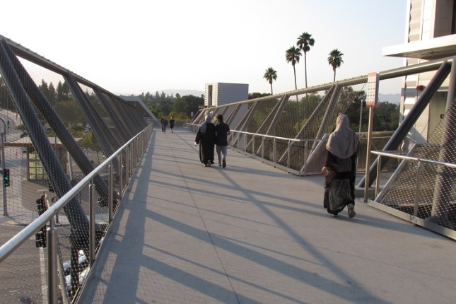Shadows stretching across the bridge as the sun goes down.